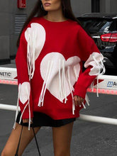 Suéter largo holgado con cuello redondo y borlas de corazón